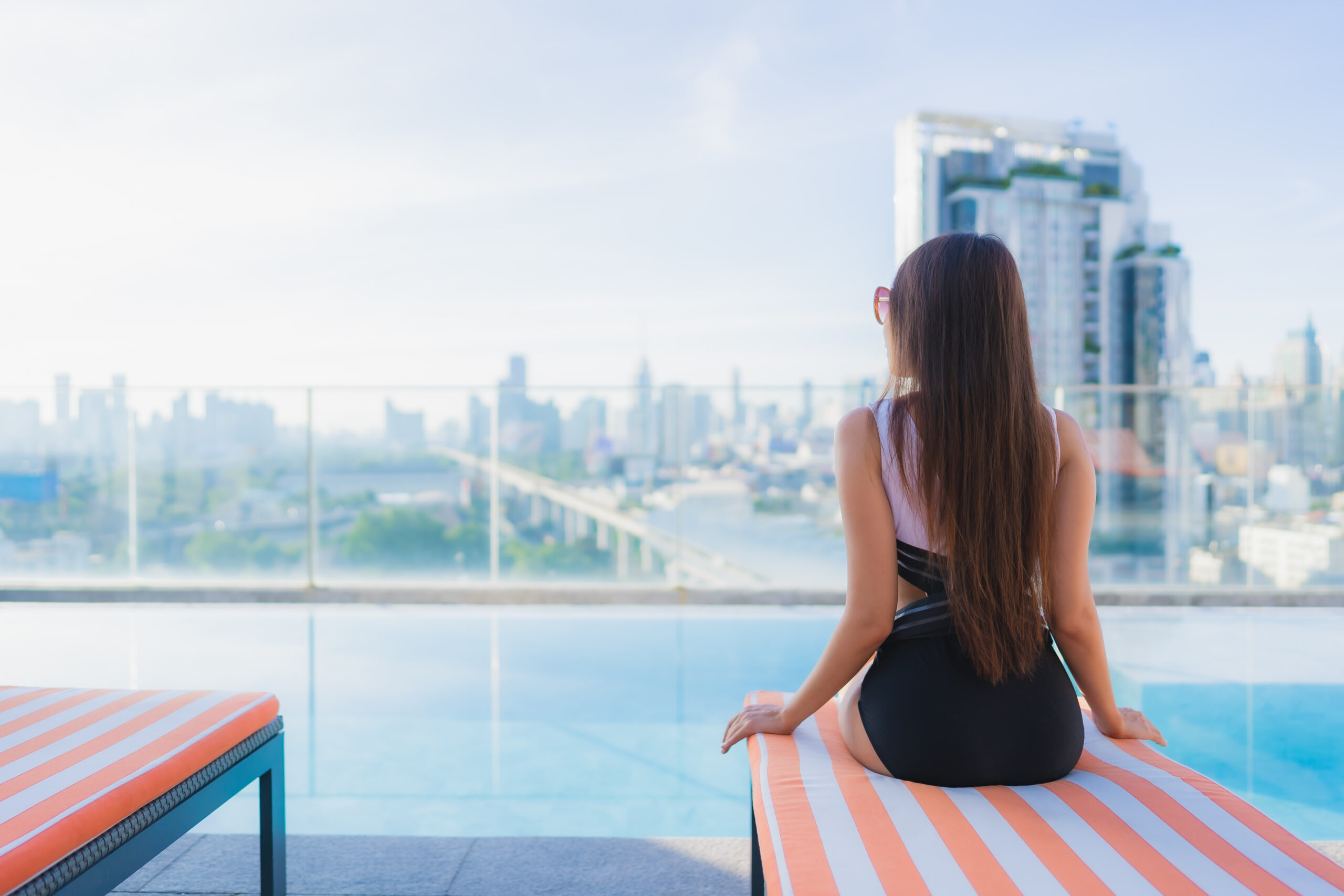 Portrait beautiful young asian woman relax leisure around swimming pool in vacation travel
